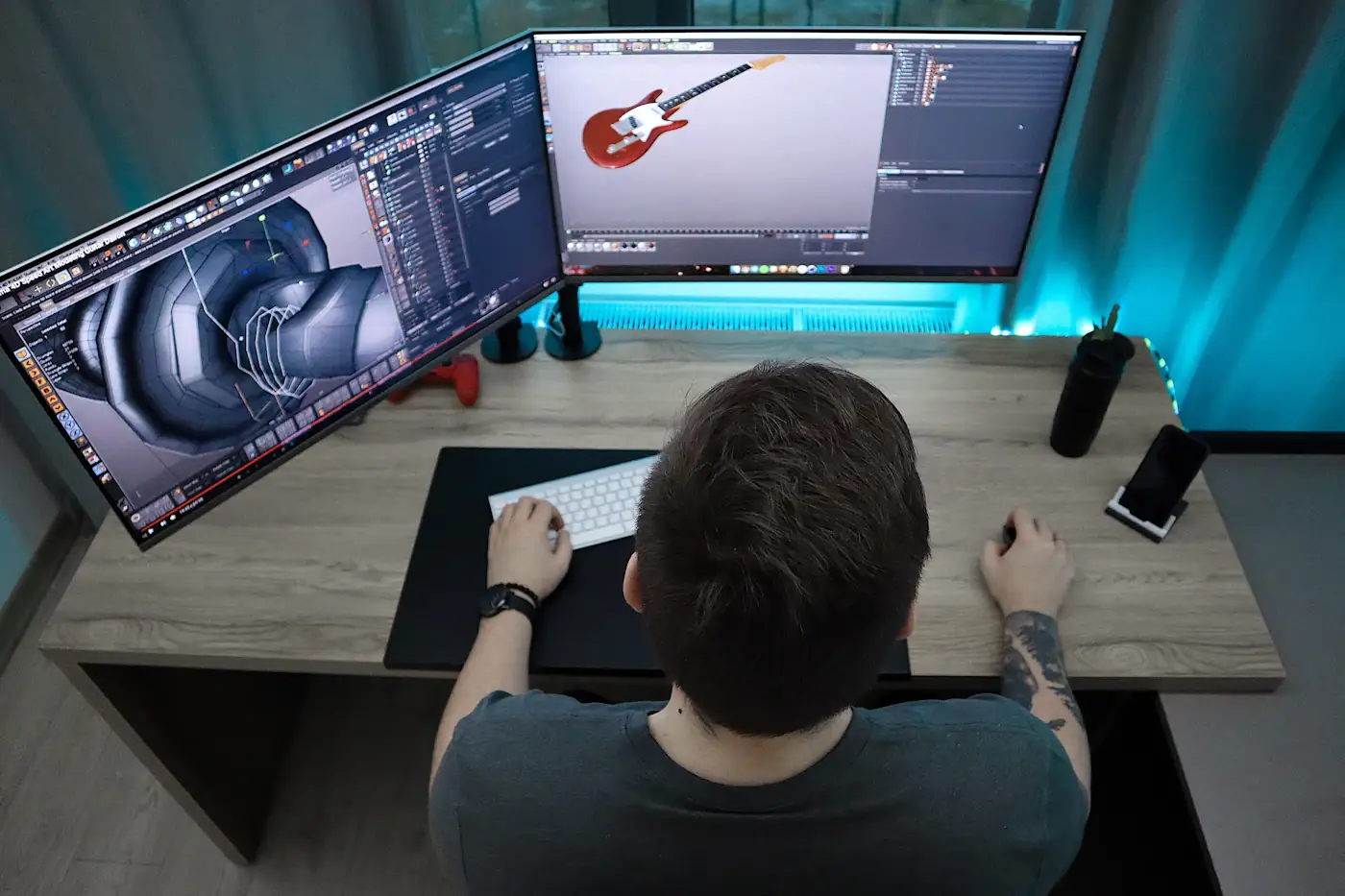 Designer modelling a product in 3D software across two monitors