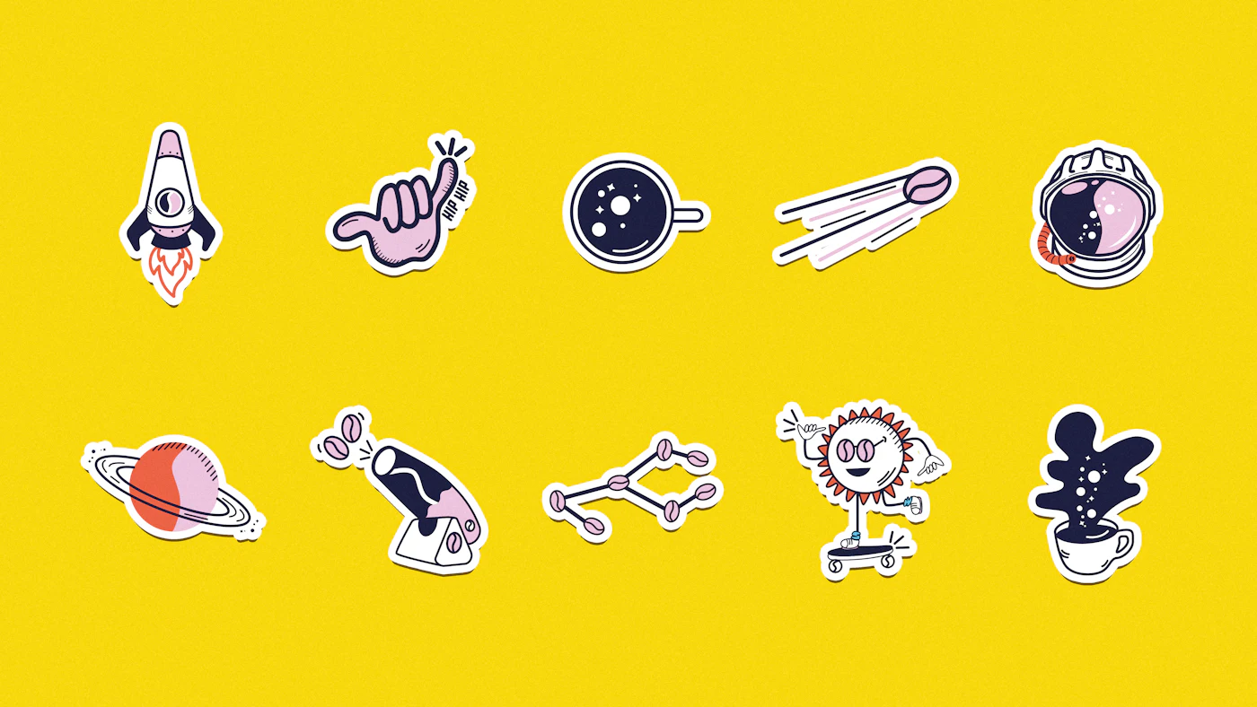 Set of colourful die-cut space themed vinyl stickers laid out on a yellow background