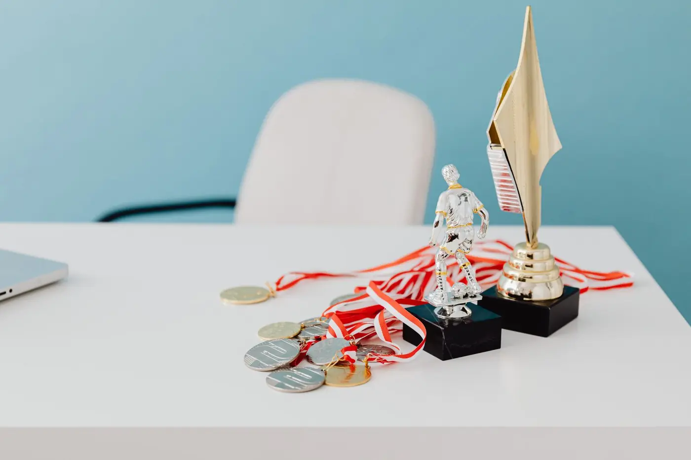 Trophies and medals on a white desk