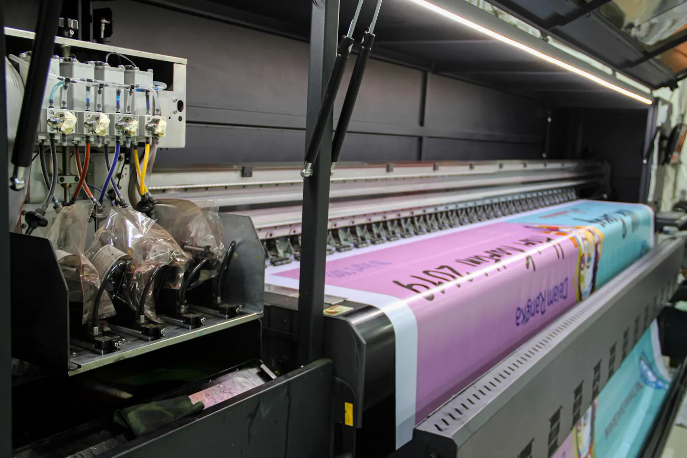 Large-format printer printing a bright pink design